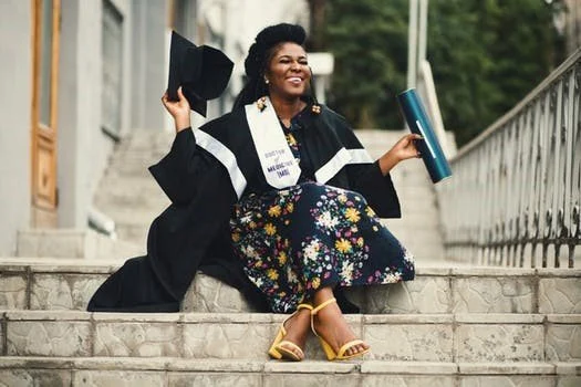 Woman Graduate Sitting On Steps