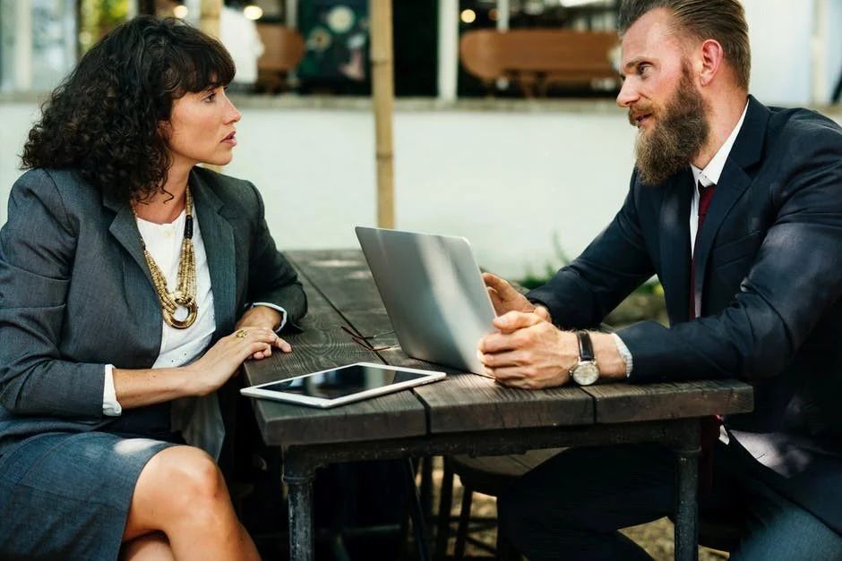 Man and Woman chatting at work