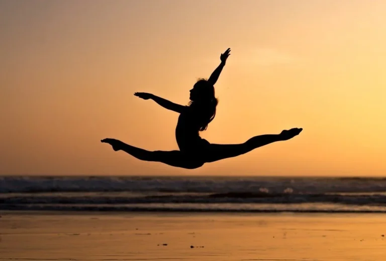 Silhouette of woman doing a split jump